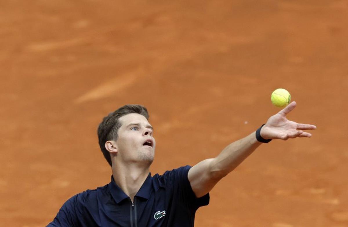Belgium's Alexander Blockx serves to Argentinia's Juan Manuel Cerundolo during their 2026 ATP Tour Madrid Open tennis tournament singles match at the Caja Magica in Madrid, on April 28, 2026.  OSCAR DEL POZO / AFP