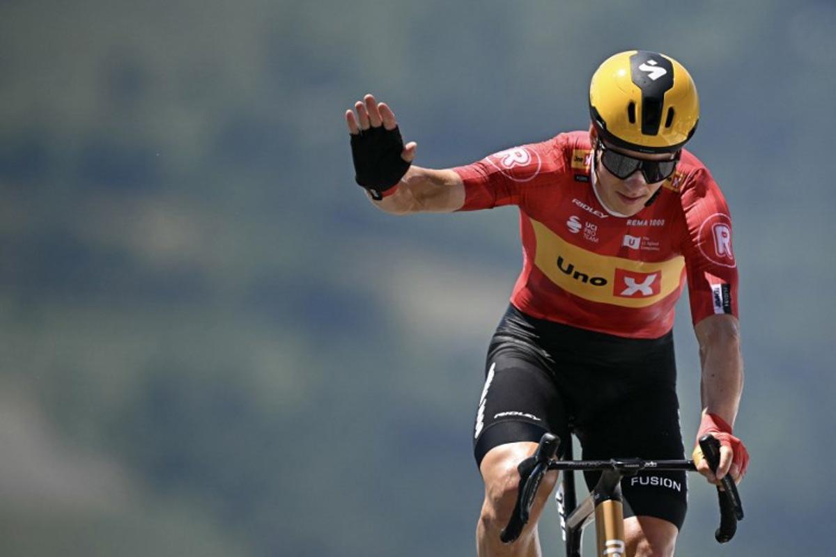 Uno-X Mobility team's Norwegian rider Jonas Abrahamsen cycles to the finish line of the 13th stage of the 112th edition of the Tour de France cycling race, 10.9 km individual time trial between Loudenvielle and Peyragudes, in the Pyrenees mountains of southwestern France, on July 18, 2025.  Loic VENANCE / AFP