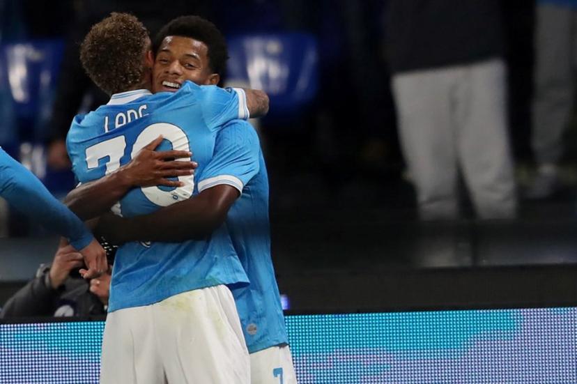 Napoli's Brazilian forward #07 David Neres (R) celebrates with a teammate after scoring his team's second goal during the Italian Serie A football match between SSC Napoli and Atalanta BC at the Diego Armando Maradona Stadium in Naples, on November 22, 2025.  CARLO HERMANN / AFP