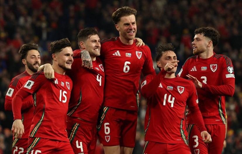 Wales' defender #04 Ben Davies (3L) celebrates scoring the team's second goal during the 2026 World Cup Group J qualifier football match between Wales and Kazakhstan, at Cardiff City Stadium, in Cardiff, on March 22, 2025.   Adrian Dennis / AFP