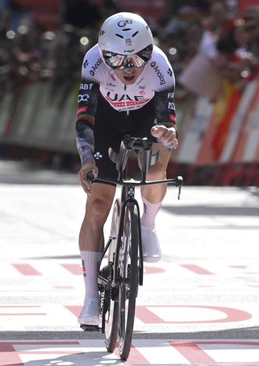 Team UAE's Portuguese rider Joao Almeida crosses the finish line of the 18th stage of the Vuelta a Espana, a 26 km race against the clock between Valladolid and Valladolid, on September 11, 2025.    Miguel RIOPA / AFP