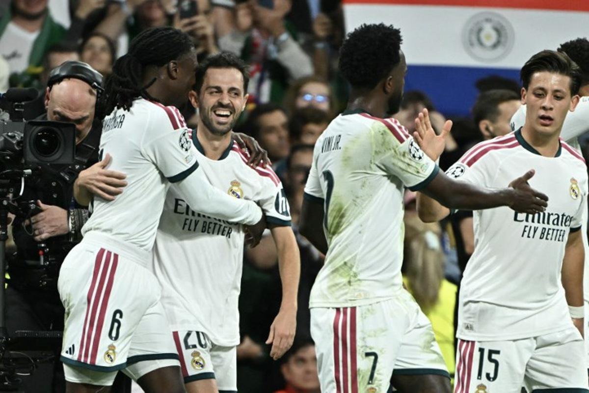 Real Madrid's Portuguese midfielder #20 Bernardo Silva (2L) celebrates scoring his team's first goal during their UEFA Champions League first round day 3 football match between Real Madrid CF and RB Leipzig at the Santiago Bernabeu stadium in Madrid on October 21, 2026.  Javier SORIANO / AFP
