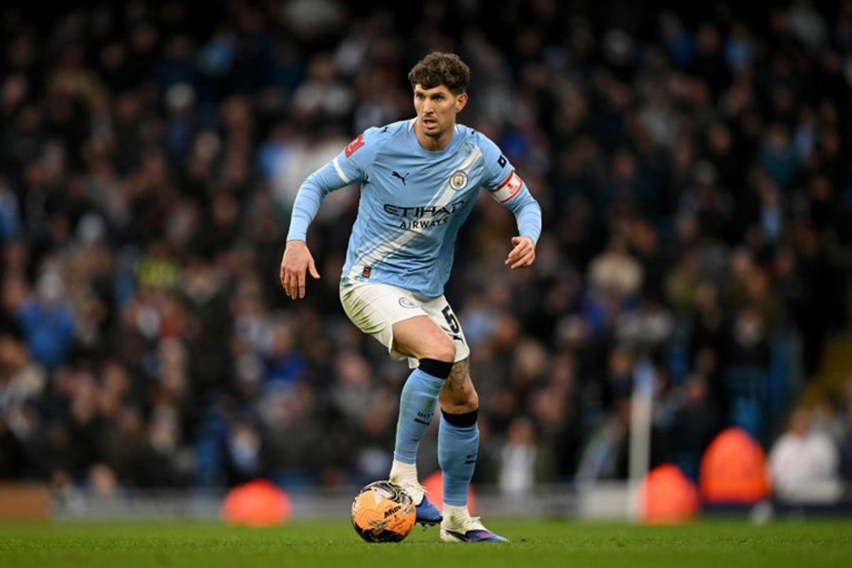 Manchester City's English defender #05 John Stones runs with the ball during the English FA Cup third round football match between Manchester City and Salford City at the Etihad Stadium in Manchester, north west England, on February 14, 2026.  Oli SCARFF / AFP