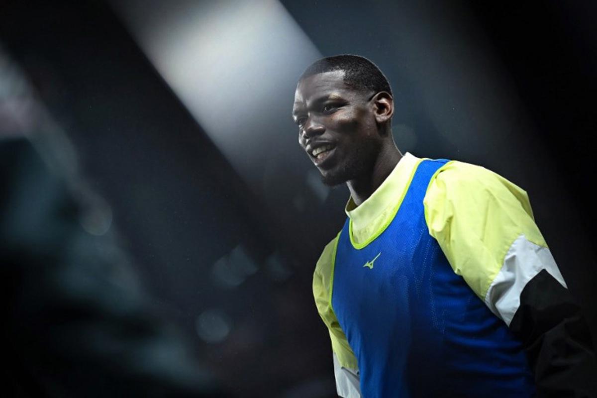 Monaco's French midfielder #08 Paul Pogba warms up prior to the French L1 football match between Stade Rennais FC and AS Monaco at the Roazhon Park stadium in Rennes, western France, on November 22, 2025.  Lou BENOIST / AFP