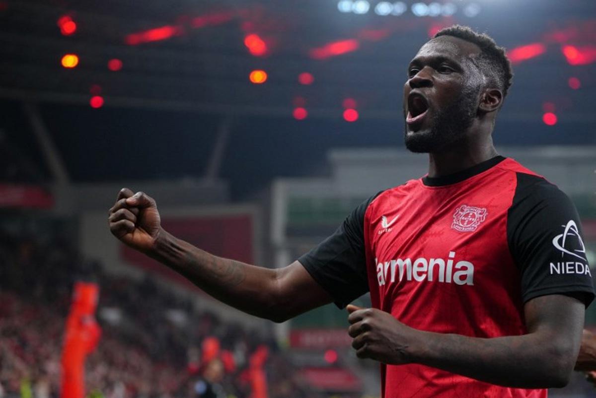 Bayer Leverkusen's Nigerian forward #22 Victor Boniface celebrates scoring the 2-1 goal with his teammates during the German first division Bundesliga football match between Bayer 04 Leverkusen and VfL Bochum in Leverkusen, western Germany on March 28, 2025.  Pau BARRENA / AFP