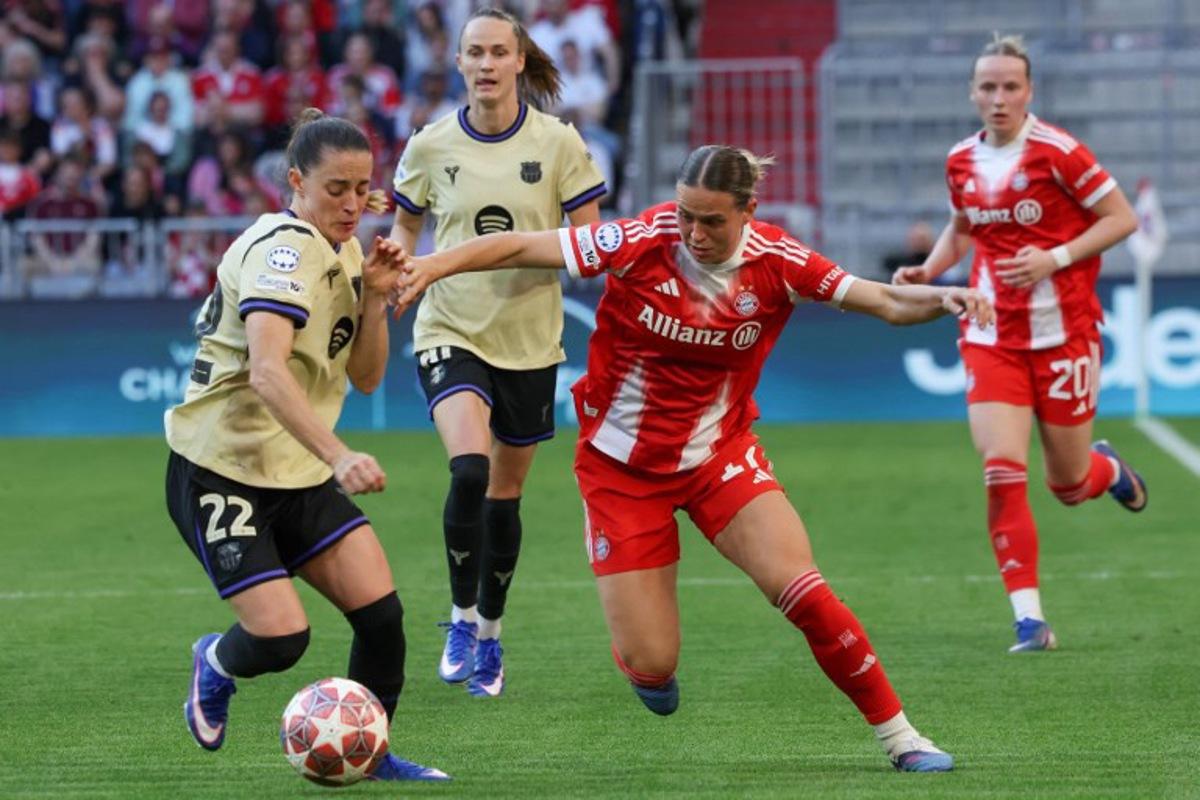 Barcelona's Spanish defender #22 Ona Batlle (L) and Bayern Munich's German forward #17 Klara Buehl vie for the ball during the UEFA Women's Champions League semi-final first leg football match between FC Bayern Munich and FC Barcelona in Munich, southern Germany on April 25, 2026.  Karl-Josef HILDENBRAND / AFP