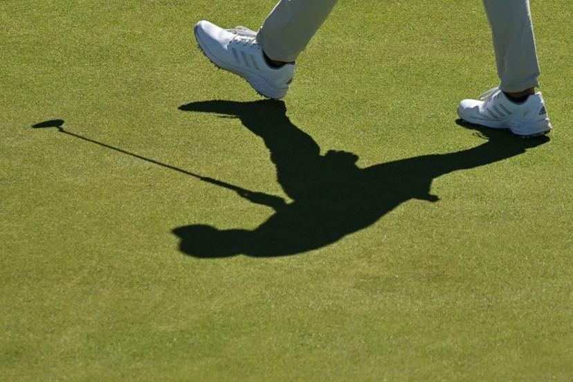 Shadow of US golfer Collin Morikawa on the 16th green during a practice round for The 150th British Open Golf Championship on The Old Course at St Andrews in Scotland on July 10, 2022.  Glyn KIRK / AFP