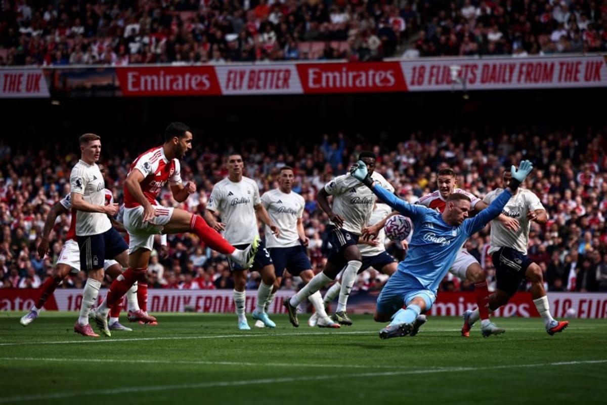 Nottingham Forest's Belgian goalkeeper #26 Matz Sels saves a shot from Arsenal's Spanish midfielder #23 Mikel Merino during the English Premier League football match between Arsenal and Nottingham Forest at the Emirates Stadium in London on September 13, 2025.   HENRY NICHOLLS / AFP