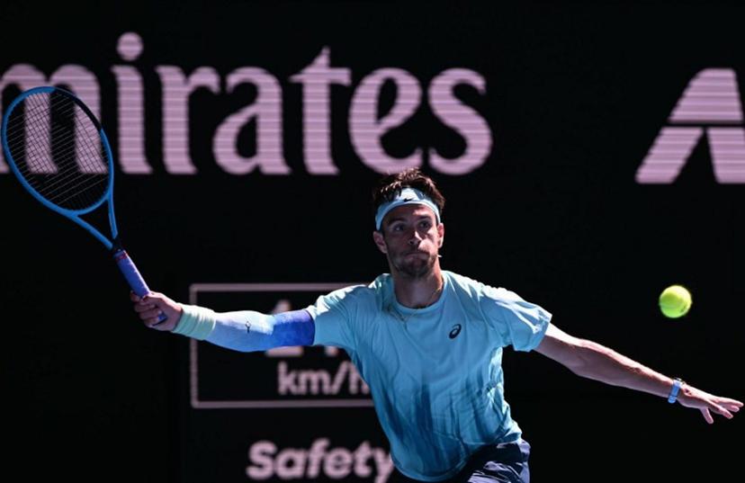 Italy's Lorenzo Musetti hits a return to USA's Taylor Fritz during their men's singles match on day nine of the Australian Open tennis tournament in Melbourne on January 26, 2026.  WILLIAM WEST / AFP