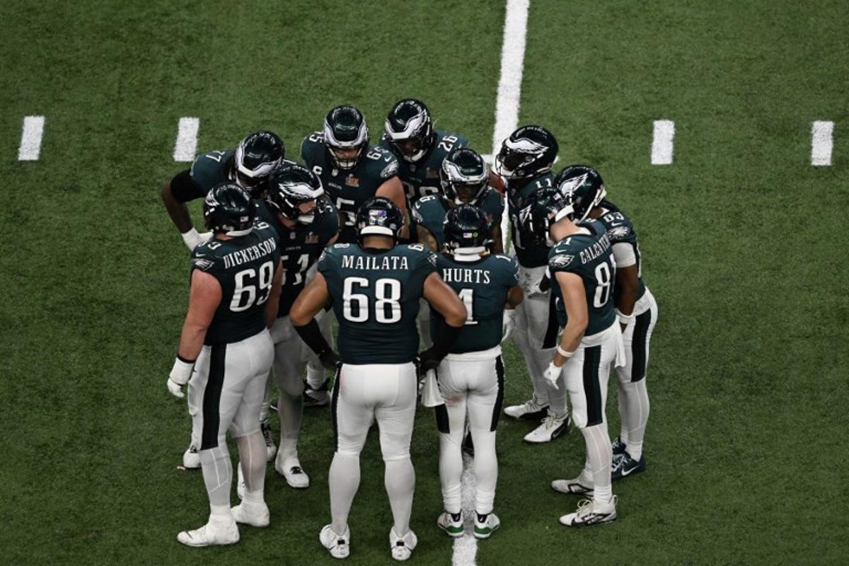 Philadelphia Eagles' quarterback #01 Jalen Hurts gathers the Eagles in the huddle during Super Bowl LIX between the Kansas City Chiefs and the Philadelphia Eagles at Caesars Superdome in New Orleans, Louisiana, February 9, 2025.  Chandan Khanna / AFP