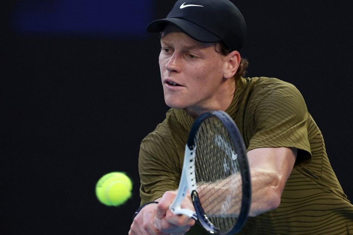 Italy's Jannik Sinner hits a return to France's Hugo Gaston during their men's singles match on day three of the Australian Open tennis tournament in Melbourne on January 20, 2026.  Martin KEEP / AFP