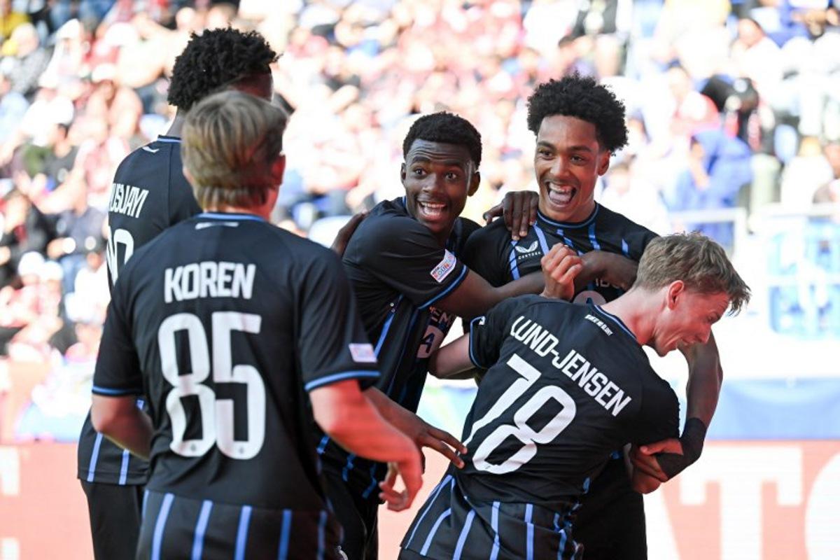 Club Brugge's English defender #90 Andre Garcia (up R) celebrates after scoring his team's second goal during the UEFA Youth League semi-final football match between Benfica and Club Brugge at Stade de la Tuiliere in Lausanne, on April 17, 2026.  Fabrice COFFRINI / AFP