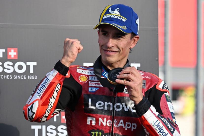 Ducati Lenovo Team rider Marc Marquez of Spain shows off his gold medal on the podium of the sprint race of MotoGP Japanese Grand Prix at the Mobility Resort Motegi in Motegi, Tochigi prefecture on October 3, 2026.   Toshifumi KITAMURA / AFP