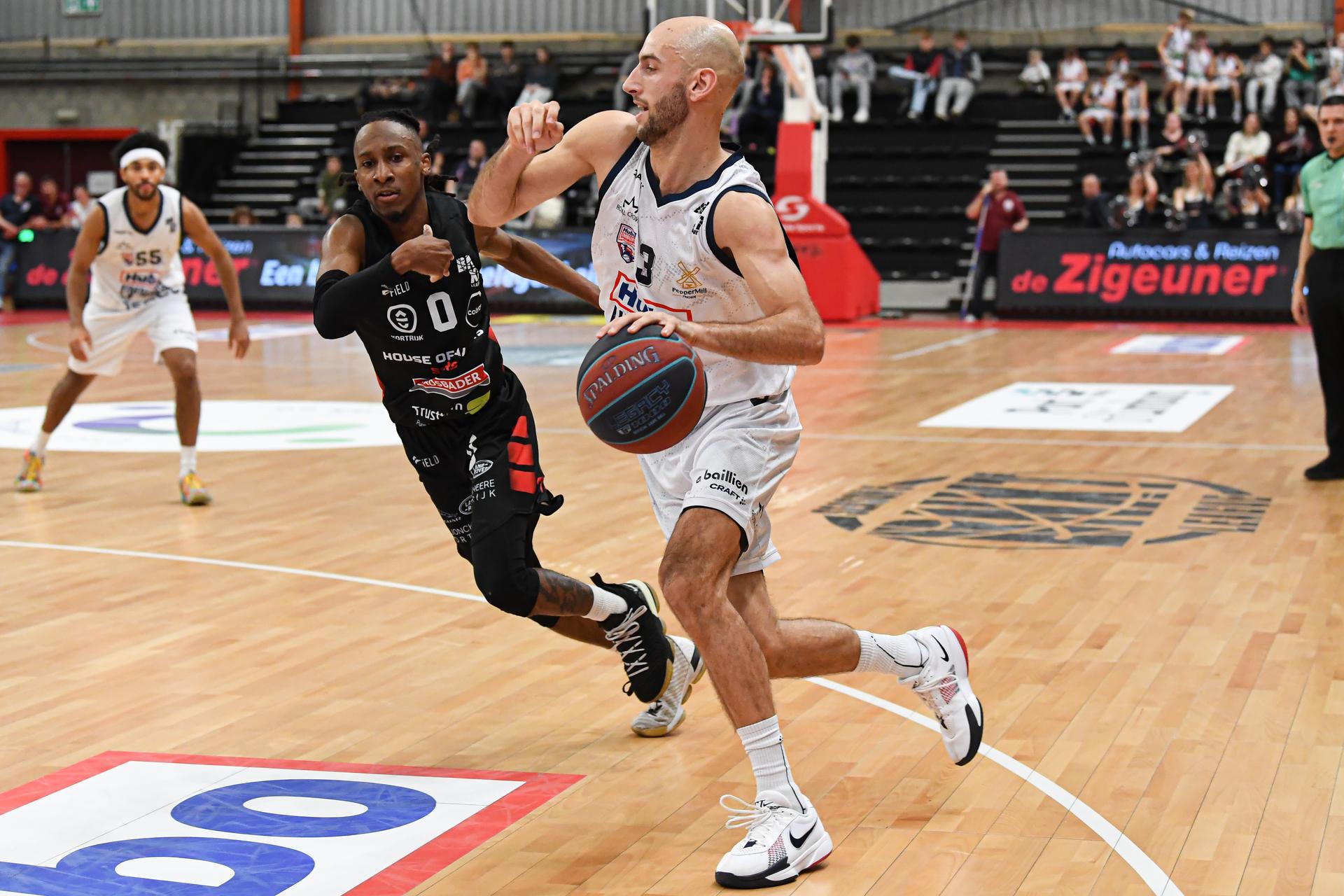 Kortrijk's Darren Williams and Limburg's Marijn Ververs pictured in action during a basketball match between Limburg United and House of Talents Spurs Kortrijk, Friday 05 December 2025 in Hasselt, on day 10 of the 'BNXT League' Belgian/ Dutch first division basket championship. BELGA PHOTO JILL DELSAUX