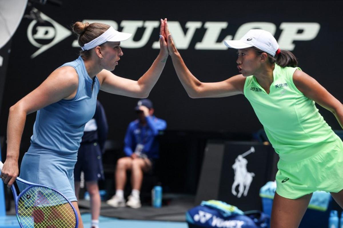 Belgium's Elise Mertens (L) reacts on a point with partner China's Zhang Shuai during their women's doubles final match against Kazakhstan's Anna Danilina and Serbia's Aleksandra Krunic on day fourteen of the Australian Open tennis tournament in Melbourne on January 31, 2026.  DAVID GRAY / AFP