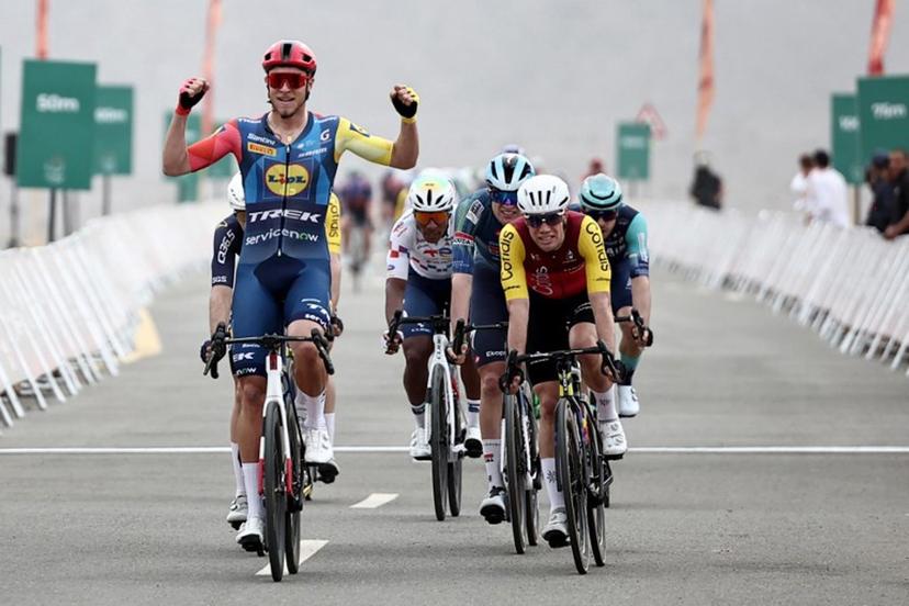 Lidl-Trek cycling team's Italian rider Jonathan Milan celebrates as he crosses the finish line to win the first stage of the AlUla Tour cycling race, a 158 km race started and finished in the Saudi desert city of AlUla, on January 27, 2026.  Anne-Christine POUJOULAT / AFP