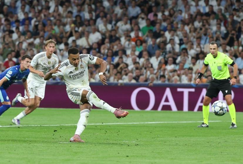 Real Madrid's French forward #10 Kylian Mbappe scores his team's first goal from the penalty spot during the UEFA Champions League first round day 1 football match between Real Madrid CF and Olympique de Marseille at the Santiago Bernabeu stadium in Madrid on September 16, 2025.  Pierre-Philippe MARCOU / AFP