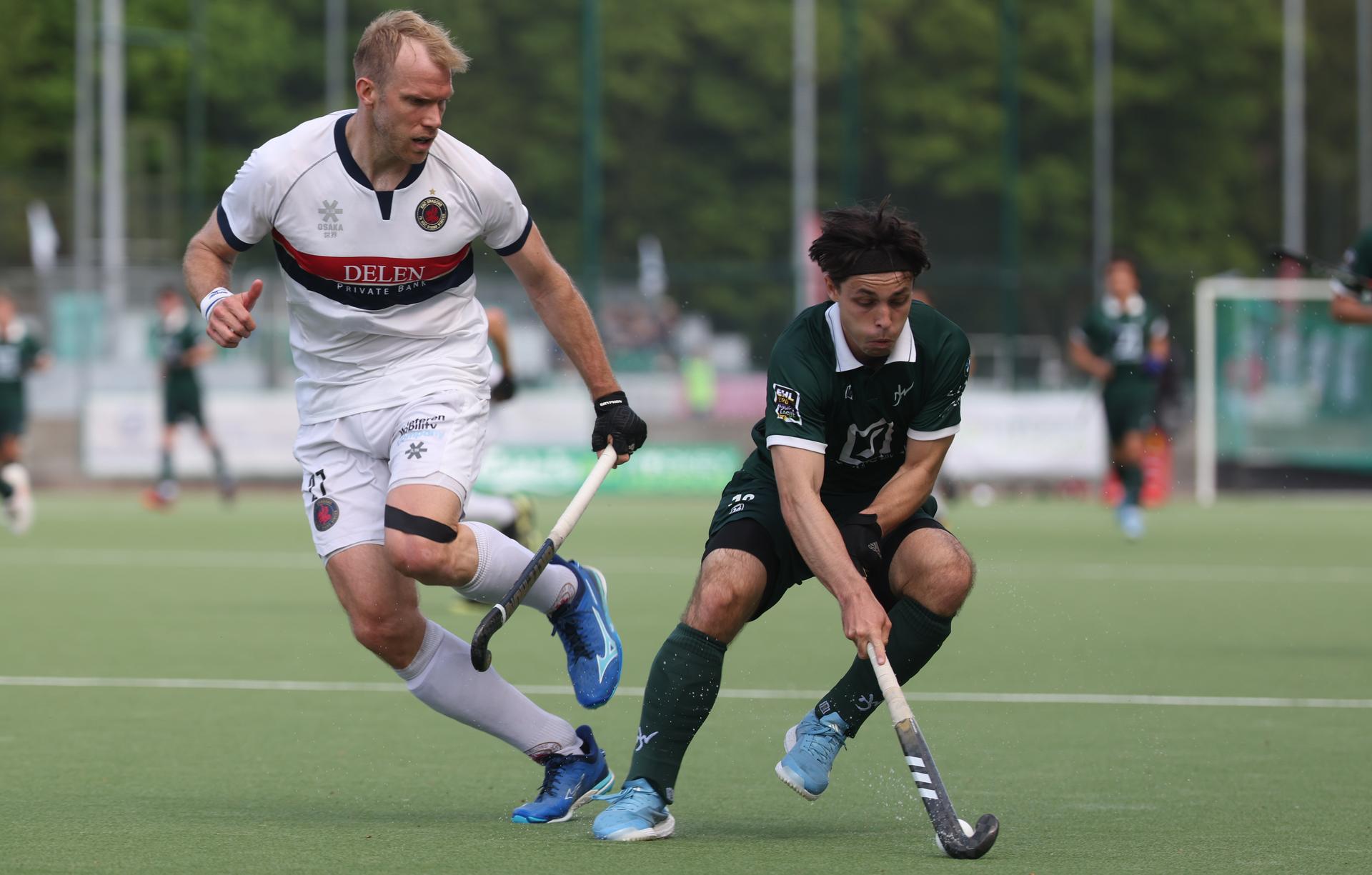 Dragons' Conor Harte and Watducks's William Ghislain fight for the ball during a hockey game between Waterloo Ducks and KHC Dragons, Sunday 27 April 2025 in Waterloo, on day 19 of the Belgian first division hockey championship. BELGA PHOTO VIRGINIE LEFOUR