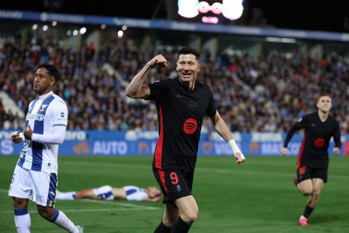 Barcelona's Polish forward #09 Robert Lewandowski celebrates after Leganes' Spanish defender #03 Jorge Saenz scored an own goal during the Spanish league football match between Club Deportivo Leganes SAD and FC Barcelona at the Estadio Municipal Butarque in Leganes, near Madrid, on April 12, 2025.  Thomas COEX / AFP