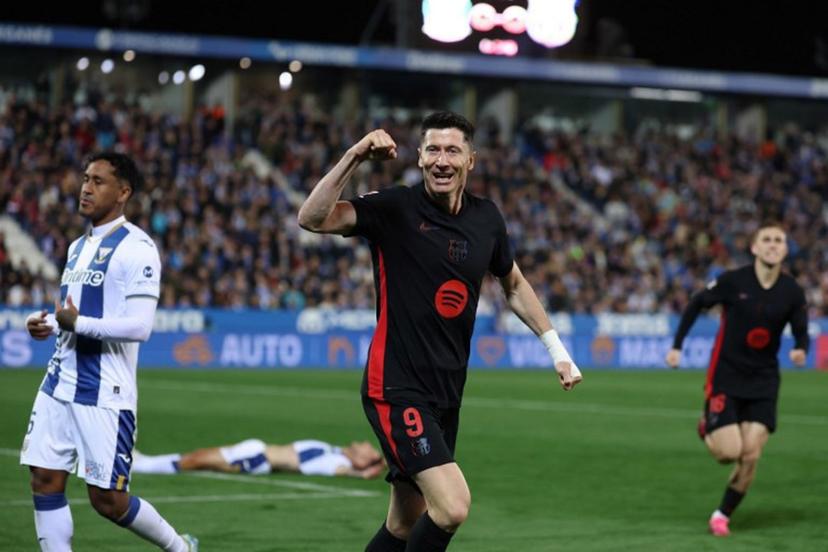 Barcelona's Polish forward #09 Robert Lewandowski celebrates after Leganes' Spanish defender #03 Jorge Saenz scored an own goal during the Spanish league football match between Club Deportivo Leganes SAD and FC Barcelona at the Estadio Municipal Butarque in Leganes, near Madrid, on April 12, 2025.  Thomas COEX / AFP