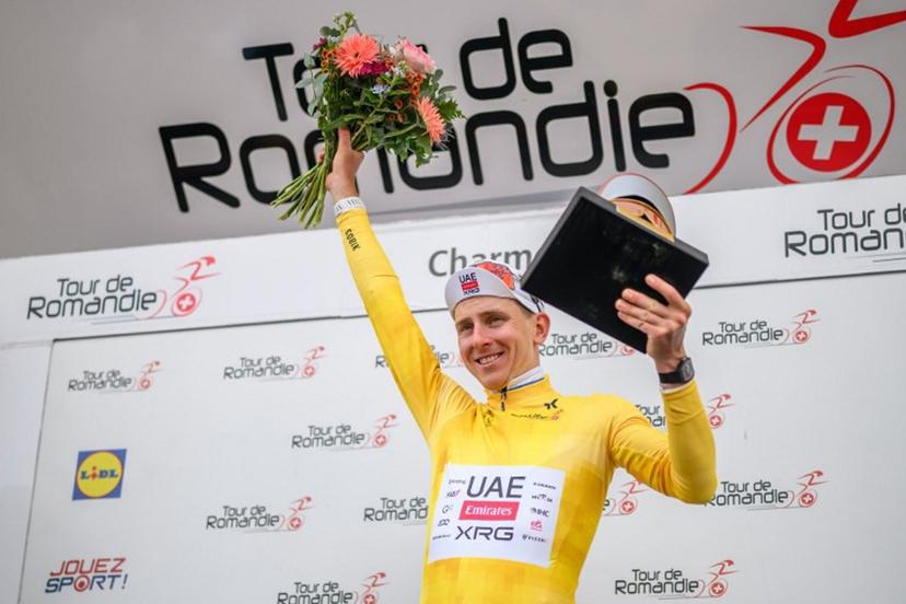 UAE Team Emirates-XRG's Slovenian rider Tadej Pogacar wearing the overall leader's yellow jersey celebrates during the podium ceremony after winning the fourth stage of the Tour of Romandie UCI cycling World tour, 149.6 km from Broc and to Charmey, in Charmey, Switzerland, on May, 2, 2026.  Fabrice COFFRINI / AFP