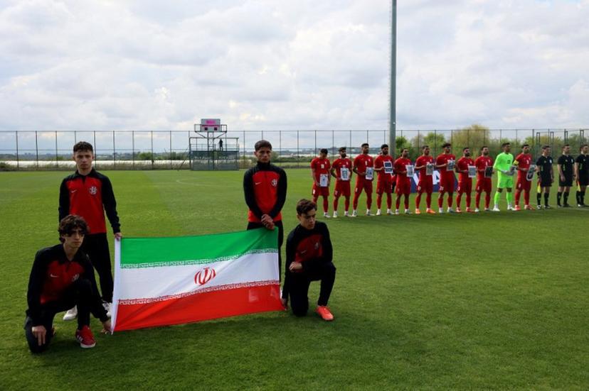 Iran's national team players pose for photographers holding pictures of children allegedly killed in a U.S. strikes in Iran, prior a friendly football match between Iran and Costa Rica, in Antalya, southern Turkey, on March 31, 2026. FIFA president Gianni Infantino told AFP Tuesday that Iran "will be at the World Cup" despite the Middle East war Adem ALTAN / AFP
