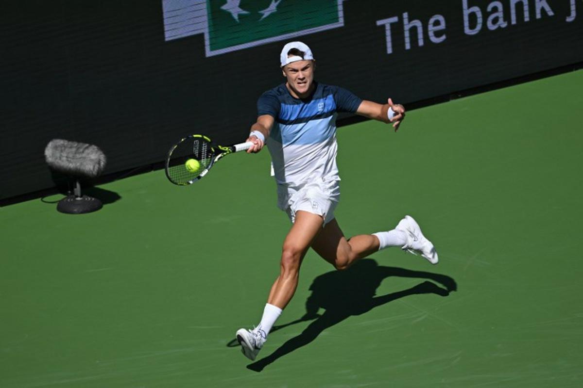 Denmark's Holger Rune returns the ball to Britain's Jack Draper during the men's singles final tennis match at the BNP Paribas Open at the Indian Wells Tennis Garden in Indian Wells, California, on March 16, 2025.  Patrick T. Fallon / AFP