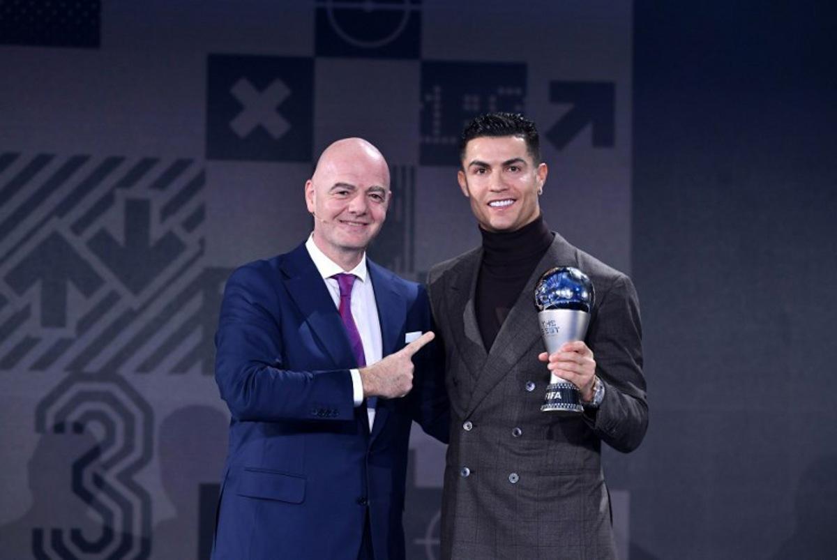 FIFA President Gianni Infantino presents the FIFA Special Best Men's award to Portuguese striker Cristiano Ronaldo (R) during the Best FIFA Football Awards 2021 in Zurich on January 17, 2022.    Harold Cunningham / POOL / AFP