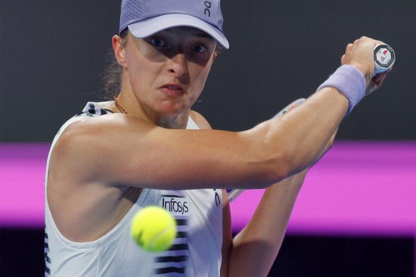 Poland's Iga Swiatek returns a shot during her women's singles quarter-final match against Greece's Maria Sakkari at the Qatar Open tennis tournament in Doha on February 12, 2026.  Karim JAAFAR / AFP