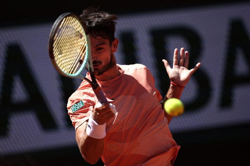 Argentina's Mariano Navone plays a forehand return to Italy's Lorenzo Musetti during their men's singles match on day 6 of the French Open tennis tournament on Court Suzanne-Lenglen at the Roland-Garros Complex in Paris on May 30, 2025.  Anne-Christine POUJOULAT / AFP