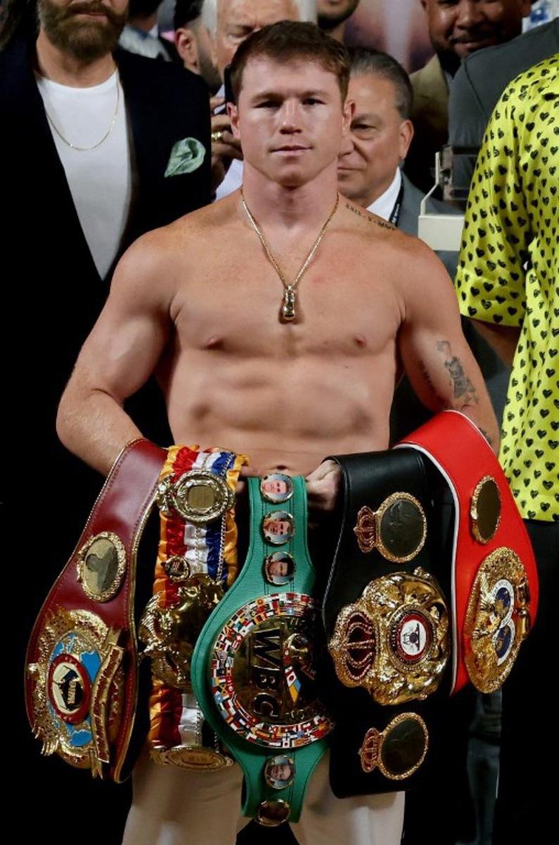 Mexican boxer Saul "Canelo" Alvarez poses with his belts before the weighing ceremony prior to his fight against British boxer John Ryder for the WBA, WBC, IBF and WBO super middleweight titles in Guadalajara, Mexico, on May 5, 2023.  ULISES RUIZ / AFP