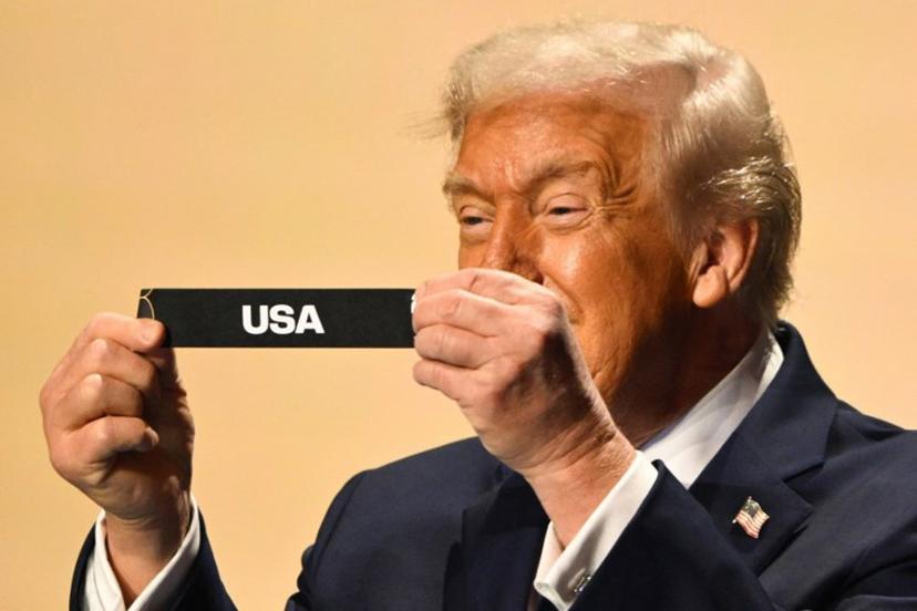 US President Donald Trump shows the card reading USA during the draw for the 2026 FIFA Football World Cup taking place in the US, Canada and Mexico, at the Kennedy Center, in Washington, DC, on December 5, 2025.  Mandel NGAN / POOL / AFP