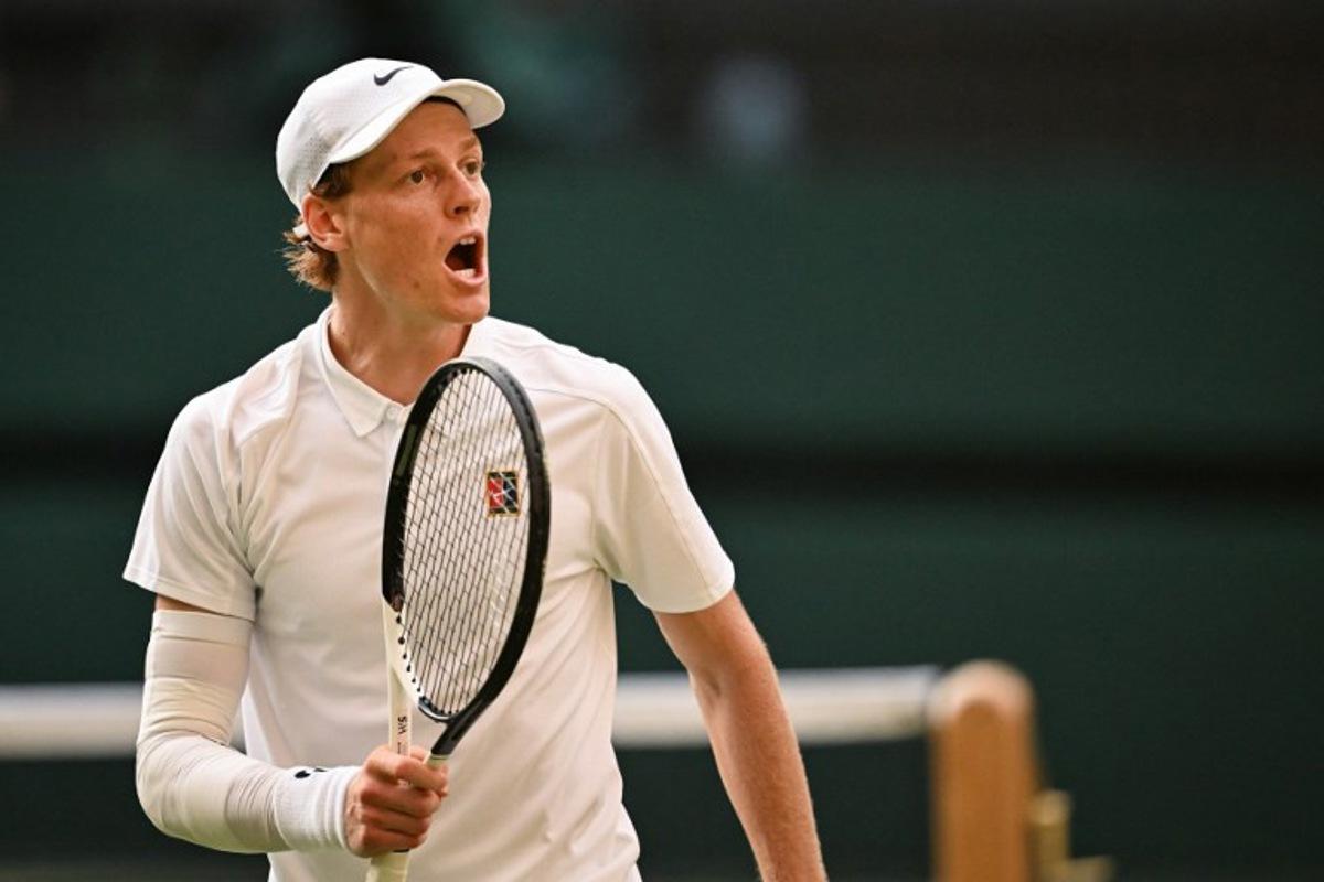 Italy's Jannik Sinner reacts as he plays against Spain's Carlos Alcaraz during their men's singles final tennis match on the fourteenth day of the 2025 Wimbledon Championships at The All England Lawn Tennis and Croquet Club in Wimbledon, southwest London, on July 13, 2025.  Kirill KUDRYAVTSEV / AFP