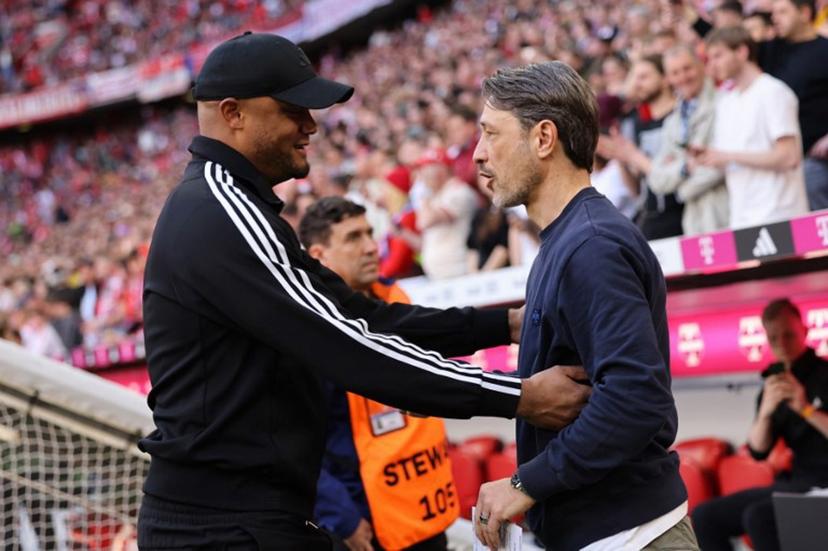 Bayern Munich's Belgian head coach Vincent Kompany (L) greets Dortmund's Croatian head coach Niko Kovac ahead the German first division Bundesliga football match between Bayern Munich and Borussia Dortmund in Munich, southern Germany, on April 12, 2025.  Alexandra BEIER / AFP