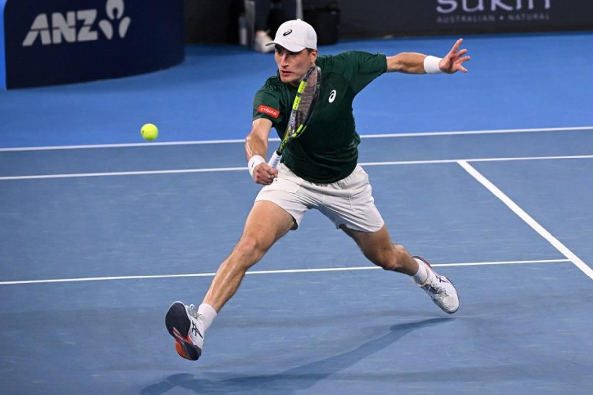 Belgium's Raphael Collignon hits a return to Bulgaria's Grigor Dimitrov during their men's singles match at the Brisbane International tennis tournament in Brisbane on January 8, 2026.  William WEST / AFP