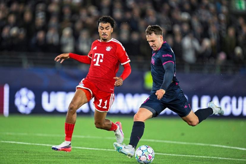 Viking's Danish forward #20 Peter Buch Christiansen (R) vies for the ball with with Bayern Munich's German defender #11 Nathaniel Brown during the UEFA Champions League football match between Viking FK and FC Bayern Munich in Stavanger, Norway on October 13, 2026.  Carina Johansen / NTB / AFP