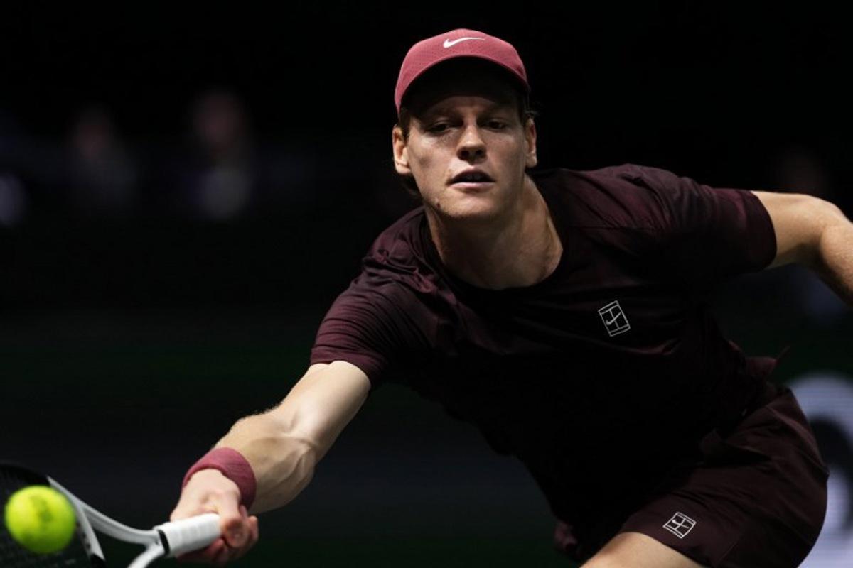 Italy's Jannik Sinner plays a forehand return to Belgium's Zizou Bergs during their men's singles match on day three of the Paris ATP Masters 1000 tennis tournament at the Paris La Défense Arena in Nanterre, on the outskirts of Paris, on October 29, 2025.  Dimitar DILKOFF / AFP