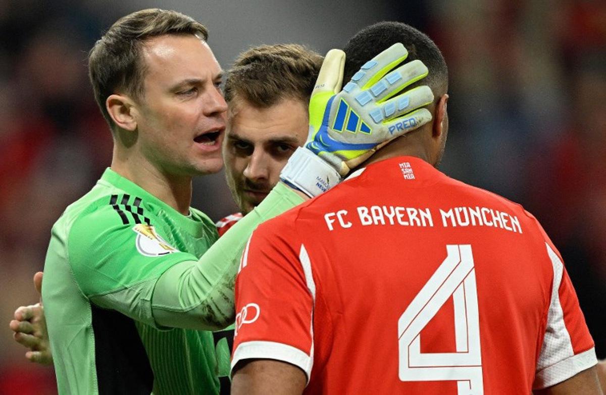 Bayern Munich's German goalkeeper #01 Manuel Neuer celebrates making a save with his defenders during the German Cup (DFB-Pokal) semi-final football match between Bayer 04 Leverkusen and FC Bayern Munich in Leverkusen, western Germany on April 22, 2026.  INA FASSBENDER / AFP