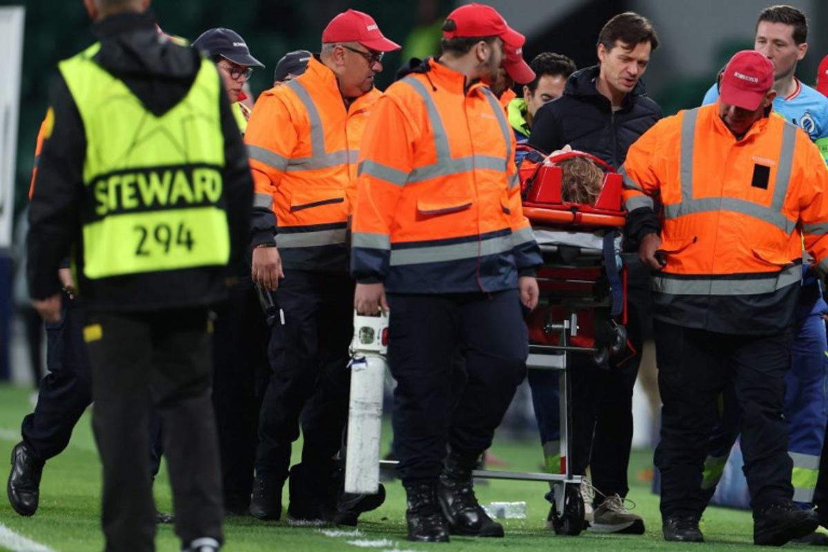 Club Brugge's Belgian goalkeeper #29 Nordin Jackers is carried on a stretcher after resulting injured during the UEFA Champions League, league phase day 5 football match between Sporting CP and Club Brugge at Jose Alvalade stadium in Lisbon on November 26, 2025.  PATRICIA DE MELO MOREIRA / AFP