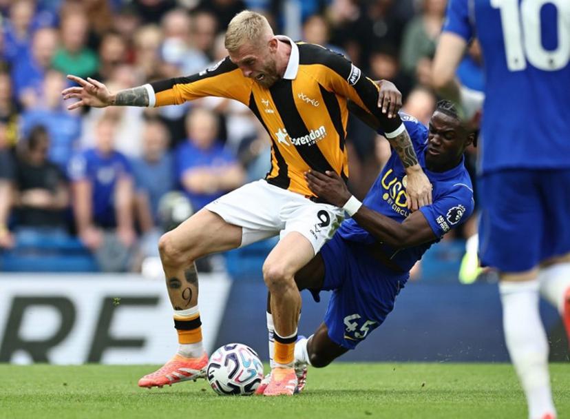 Chelsea's Belgian midfielder #45 Romeo Lavia (R) fouls Hull City's Scottish striker #09 Oli McBurnie during the English Premier League football match between Chelsea and Hull City at Stamford Bridge in London on September 12, 2026.  Henry NICHOLLS / AFP