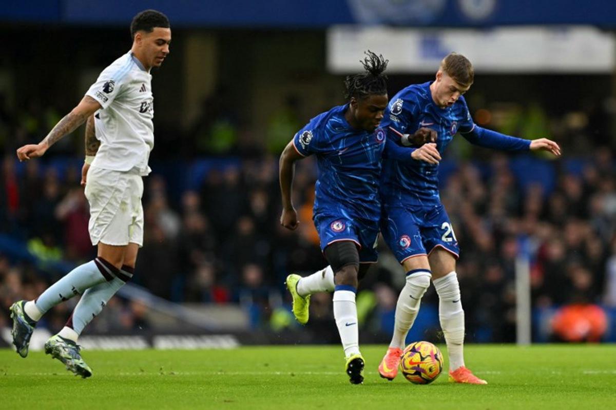 Chelsea's Belgian midfielder #45 Romeo Lavia and Chelsea's English midfielder #20 Cole Palmer (R) collide during the English Premier League football match between Chelsea and Aston Villa at Stamford Bridge in London on December 1, 2024.  Glyn KIRK / AFP