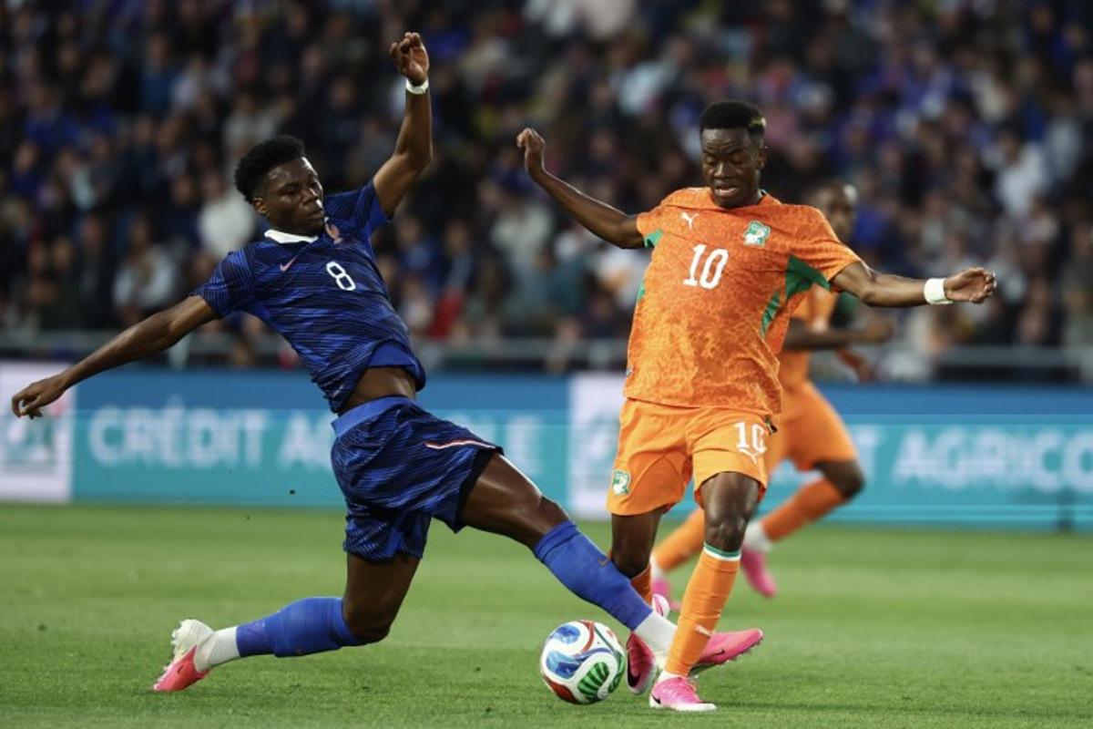 France's midfielder #08 Aurelien Tchouameni (L) fights for the ball with Ivory Coast's forward #10 Simon Adingra (R) during the international friendly football match between France and Ivory Coast ahead of the 2026 FIFA World Cup football tournament at the Stade de la Beaujoire in Nantes, western France, on June 4, 2026.  FRANCK FIFE / AFP