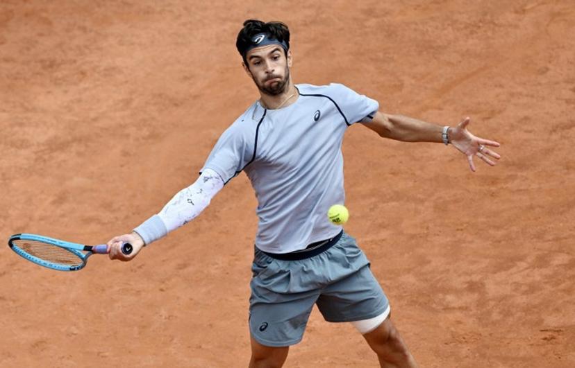 Italy's Lorenzo Musetti hits a return to Norway's Casper Ruud during the ATP Rome Open tennis tournament at Foro Italico in Rome on May 12, 2026.   Tiziana FABI / AFP