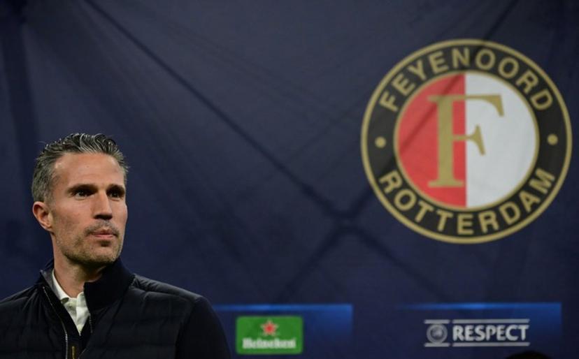 Feyenoord's Dutch head coach Robin van Persie looks on next to team logo before the UEFA Champions League round of 16 second-leg football match between Inter Milan and Feyenoord Rotterdam at the San Siro Stadium in Milan, on March 11, 2025.  Piero CRUCIATTI / AFP