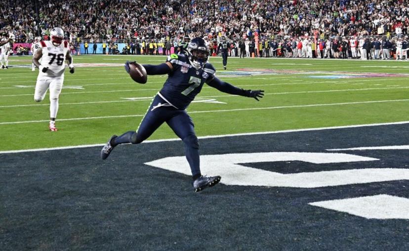 Seattle Seahawks' linebacker #07 Uchenna Nwosu scores a touchdown during Super Bowl LX between the New England Patriots and the Seattle Seahawks at Levi's Stadium in Santa Clara, California on February 8, 2026.  JOSH EDELSON / AFP