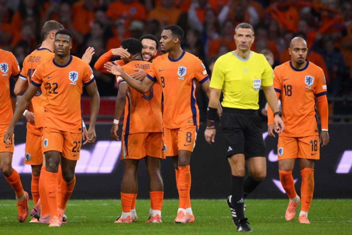 Netherlands' forward #10 Memphis Depay (4L) celebrates with teammates after scoring his team's third goal from the penalty spot during the FIFA World Cup 2026 Group G qualification football match between Netherlands and Finland, at the Johan Cruyff Arena in Amsterdam, on October 12, 2025.  JOHN THYS / AFP