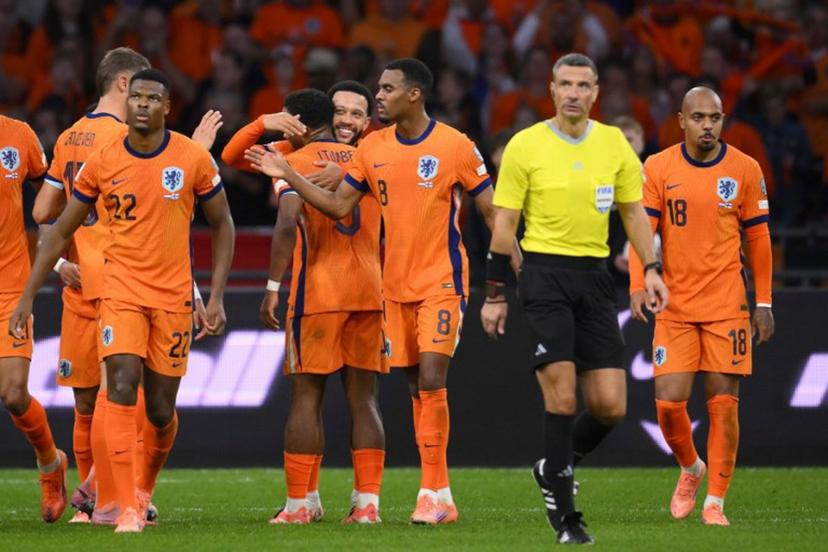 Netherlands' forward #10 Memphis Depay (4L) celebrates with teammates after scoring his team's third goal from the penalty spot during the FIFA World Cup 2026 Group G qualification football match between Netherlands and Finland, at the Johan Cruyff Arena in Amsterdam, on October 12, 2025.  JOHN THYS / AFP