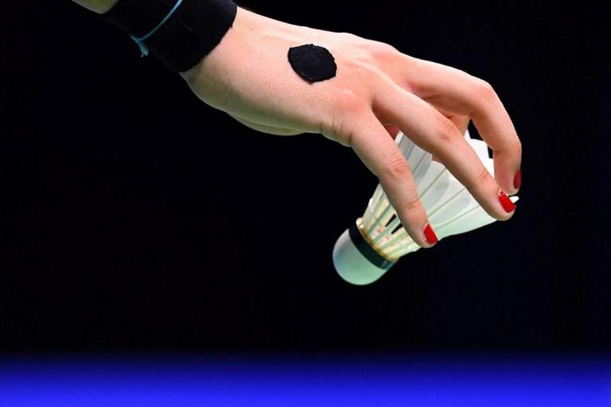 Carolina Marin of Spain holds a shuttlecock in the women's single semifinal match against He Bingjiao of China during the badminton World Championships in Nanjing, Jiangsu province on August 4, 2018.  Johannes EISELE / AFP