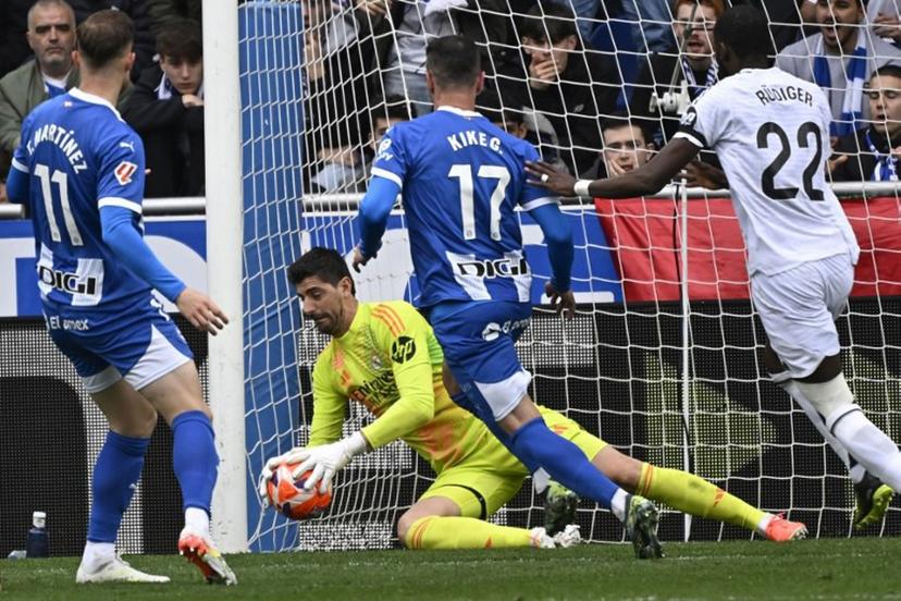 Real Madrid's Belgian goalkeeper #01 Thibaut Courtois makes a save during the Spanish league football match between Deportivo Alaves and Real Madrid CF at the Mendizorroza stadium in Vitoria on April 13, 2025.  ANDER GILLENEA / AFP