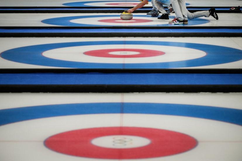 USA's John Shuster curls the stone during the men's bronze medal game of the Beijing 2022 Winter Olympic Games curling competition between Canada and USA at the National Aquatics Centre in Beijing on February 18, 2022.  Jeff PACHOUD / AFP